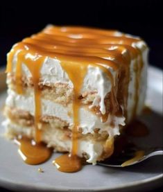 a piece of cake with caramel drizzled on top and frosting