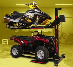 two atvs and a snowmobile on a lift