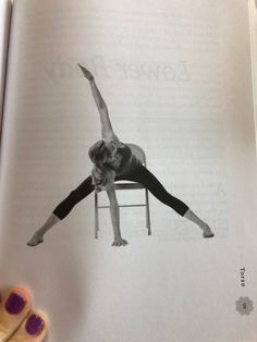 an open book showing a woman doing yoga on a chair with her legs spread out