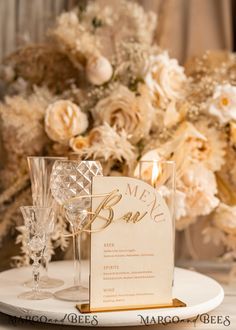 a table setting with menu cards and wine glasses