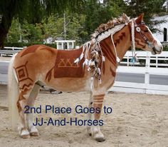 a brown horse standing on top of a dirt field