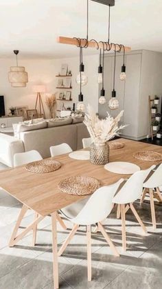 a dining room table with white chairs and wooden tables