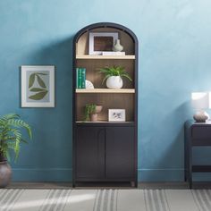 a room with blue walls and a black bookcase