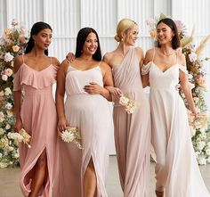 four bridesmaids in pink dresses posing for the camera