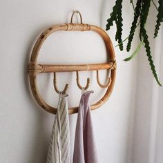 two towels are hanging on a bamboo rack