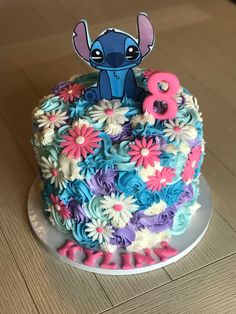 the birthday cake is decorated with flowers and an image of stitching stitchs on it