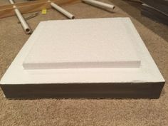 a white box sitting on top of a carpeted floor