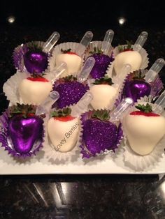 chocolate covered strawberries are arranged in the shape of heart shaped candies on a white platter