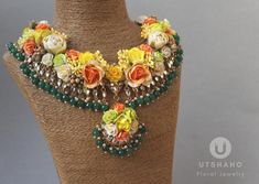 the necklace is adorned with flowers and beads