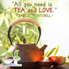 a tea pot and two cups sit on a table with bamboo leaves in the background