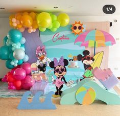 a party with balloons and mickey mouse decorations