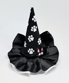 Paws miniature witch hat for babies, girls, adults, and pets. Mini hat size is approximately 3.5 inches wide by 4 inches tall. Miniature hat can be attached to a metal alligator clip, a circular Velcro for cranial helmets, a soft elastic headband, ot ribbon for pets. Please choose the finish: -3cm Velcro  -2.6 inches metal alligator clip  -5/8 by 16 or 18 inches soft elastic headband  -3/8 by 18 or 25 inches ribbon (for pets). Finish color: -White Velcro  -Metal Clip  -Black  -White  -There may Witch Hats White, Black Adjustable Witchy Mini Hats, Adjustable Black Witchy Mini Hat, Black Cat Witch Hat, Black Cat In Witch Hat, Halloween Witch Hat, Soft Headbands, Elastic Headbands, Witch Hat