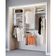 an open closet with clothes and shoes hanging on the wall next to each other,