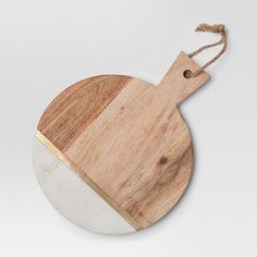 a wooden cutting board with a white and gold stripe