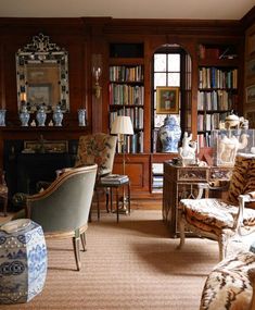 a living room filled with lots of furniture and bookshelves