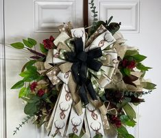 a christmas wreath on the front door decorated with deer heads