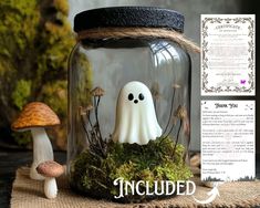 there is a jar with a ghost in it on the table next to some mushrooms