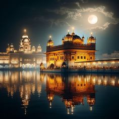 the golden building is lit up at night with lights on it's sides and reflecting in the water