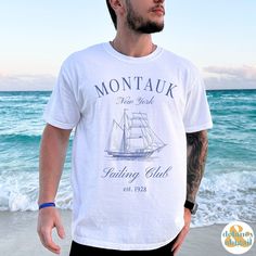 Get ready to be OBSESSED with your new Montauk Sailing Club Tee. It's the cutest and most trendy way to emit all those important Old Money Aesthetics vibes! This is the perfect Social/Sailing Club Shirt! Great as a gift for all the Boating and Sailing lovers out there! Comfort Colors introduces the soft-washed, 100% ring-spun cotton, garment-dyed fabric that brings extra coziness to your wardrobe while the relaxed fit makes it an excellent daily choice. The double-needle stitching throughout the tee makes it highly durable while the lack of side-seams helps the shirt retain its tubular shape.  ❤ The Comfort Colors 1717 tee is made with medium fabric (6.1 oz/yd² (206.8 g/m      consisting of high quality, 100% ring-spun US cotton for long-lasting comfort. ❤ The relaxed fit keeps the wearer White Nautical Short Sleeve Tops, White Short Sleeve Nautical Shirt, White Nautical Style Short Sleeve T-shirt, White Nautical Short Sleeve T-shirt, White Short Sleeve Nautical T-shirt, Summer Nautical Cotton Shirt, Nautical Short Sleeve Cotton Shirt, White Nautical Cotton Shirt, Nautical Style Cotton Tops For Vacation