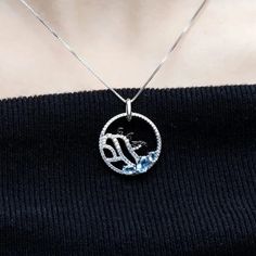 "Dive into a world of Arctic whimsy with our delightful sterling silver and gold necklace, featuring a charming image of three playful penguins frolicking on an iceberg, accented with your choice of blue topaz, nano-sapphire, or rhodolite gemstones. 🐧❄️💎✨ This enchanting piece captures the joy and camaraderie of these beloved creatures in their icy habitat. Meticulously crafted with intricate detailing, the penguins evoke a sense of curiosity and friendship, inviting you to join in their playf Diamond White Sapphire Jewelry Gift, Diamond White Sapphire Jewelry For Gift, White Sapphire Jewelry For Gift, Fine Jewelry Blue Topaz Round Pendant, Blue Topaz Round Pendant Fine Jewelry, Diamond White Topaz Jewelry Gift, Diamond White Topaz Jewelry As Gift, Diamond White Topaz Jewelry For Gifts, White Gold Pendant Birthstone Necklace