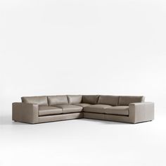 an l - shaped sectional sofa with the corner section facing off to the side, in front of a white background