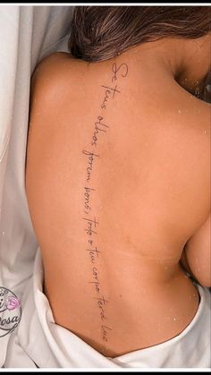 the back of a woman's body with writing on it