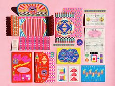 an assortment of brightly colored papers on a pink background