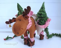 a stuffed moose with christmas decorations around it's neck