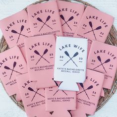 some pink packets with paddles on them sitting in a basket next to each other