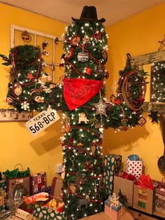 a cross decorated with christmas decorations and presents