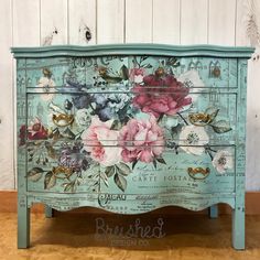 an old dresser with flowers painted on it