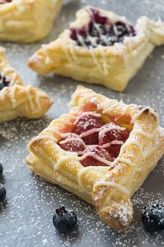 blueberries and raspberry pastries on a baking sheet