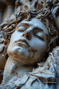 a close up of a statue of a man's head with his eyes closed