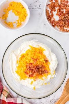 the ingredients to make an orange and white cake are shown in bowls on top of a marble countertop