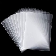 six clear plastic sheets are stacked on top of each other