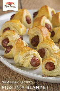 a white plate topped with pigs in a blanket