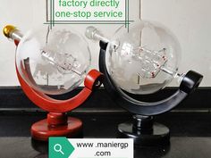 two glass globes sitting next to each other on top of a black countertop