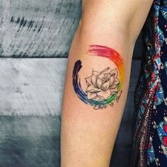 a woman's arm with a tattoo on it that has a flower in the center