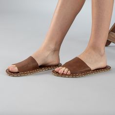 Introducing the Lion Barefoot Slide Sandals the perfect addition to your summer wardrobe. Handmade in Turkey with 100% natural materials, these sandals are crafted with a natural leather upper and a water buffalo leather sole, ensuring maximum comfort and breathability for your feet. With a wider toe box, your toes have enough room to spread and relax, promoting a more natural gait and posture. The "zero-drop" non-elevated heel helps maintain proper posture as well. Available in sizes ranging fr