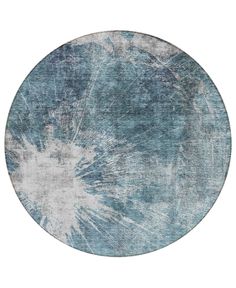 a round rug with blue and white designs on the top, in front of a white background