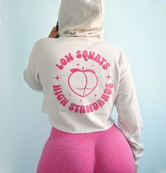 Low squats high standards hoodie. *Model is a size 6 and wearing a small.* *Heather dust gets pink text. All other colors get black or white text.* CROPPED HOODIE - 52% cotton and 48% poly-fleece - Drop shoulder and relaxed fit - Bella + Canvas brand - Size down if you're stuck between 2 sizes Fitted Hoodie Sweatshirt For Workout, Pink Relaxed Fit Sweats For Sports, Pink Sports Sweats With Drawstring Hood, Pink Activewear With Drawstring Hood For Sports, Pink Hoodie With Drawstring For The Gym, Pink Sports Hoodie For Sweats, Pink Sports Sweats Hoodie, Pink Sweats With Drawstring Hood For Sports, Pink Stretch Sweatshirt For Sports