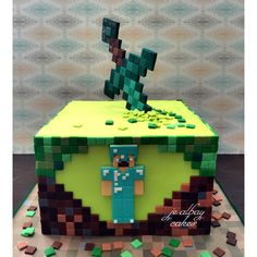 a cake made to look like an old school video game console with a pixel figure on top