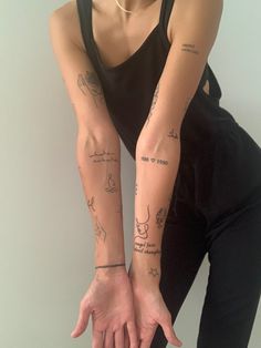 a woman with tattoos on her arm and wrist