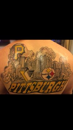 the back of a man's shoulder with pittsburgh tattoos on it