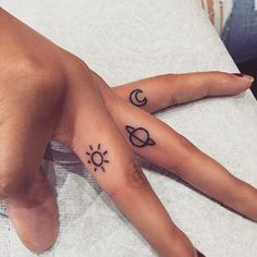 two hands with tattoos on them are sitting next to each other, one has a sun and the other is a crescent