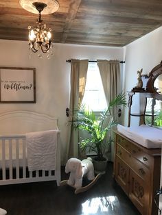 a baby's room with a crib, dresser and bed