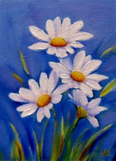 some white daisies are on a blue background