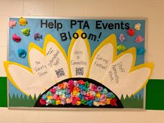 a bulletin board with paper flowers and writing on it that says help pta events bloom