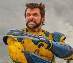 a man in yellow and blue outfit holding two swords