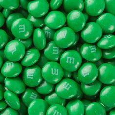 green candy candies with white writing on them